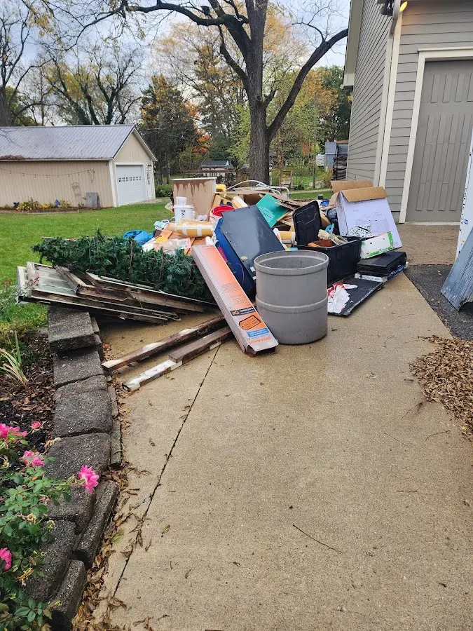 Dumpster being loaded with debris for Estate Cleanout Dumpster Rental in Lake Barrington
